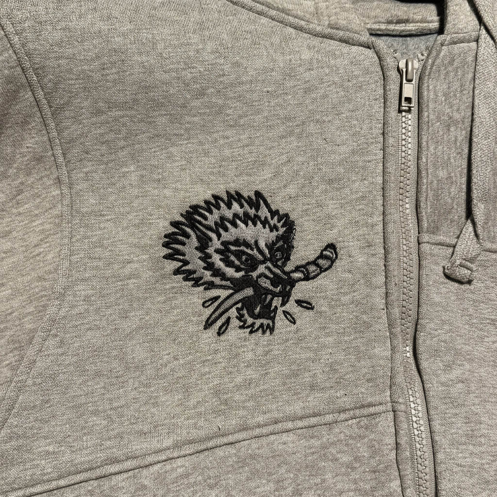 Gray hoodie with a black embroidered design on the chest