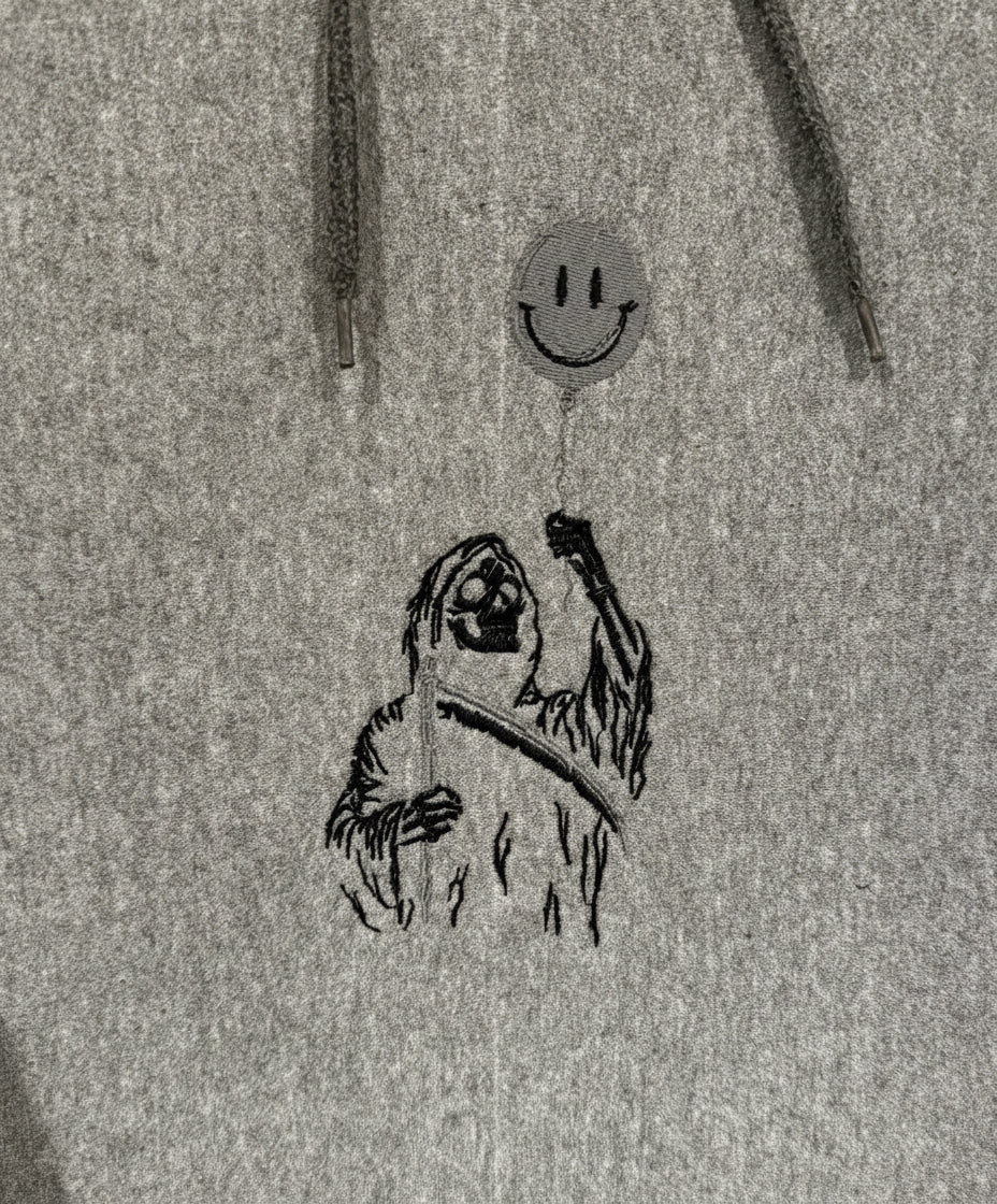 Stylized illustration of a sloth holding a smiley face balloon on a textured gray background.